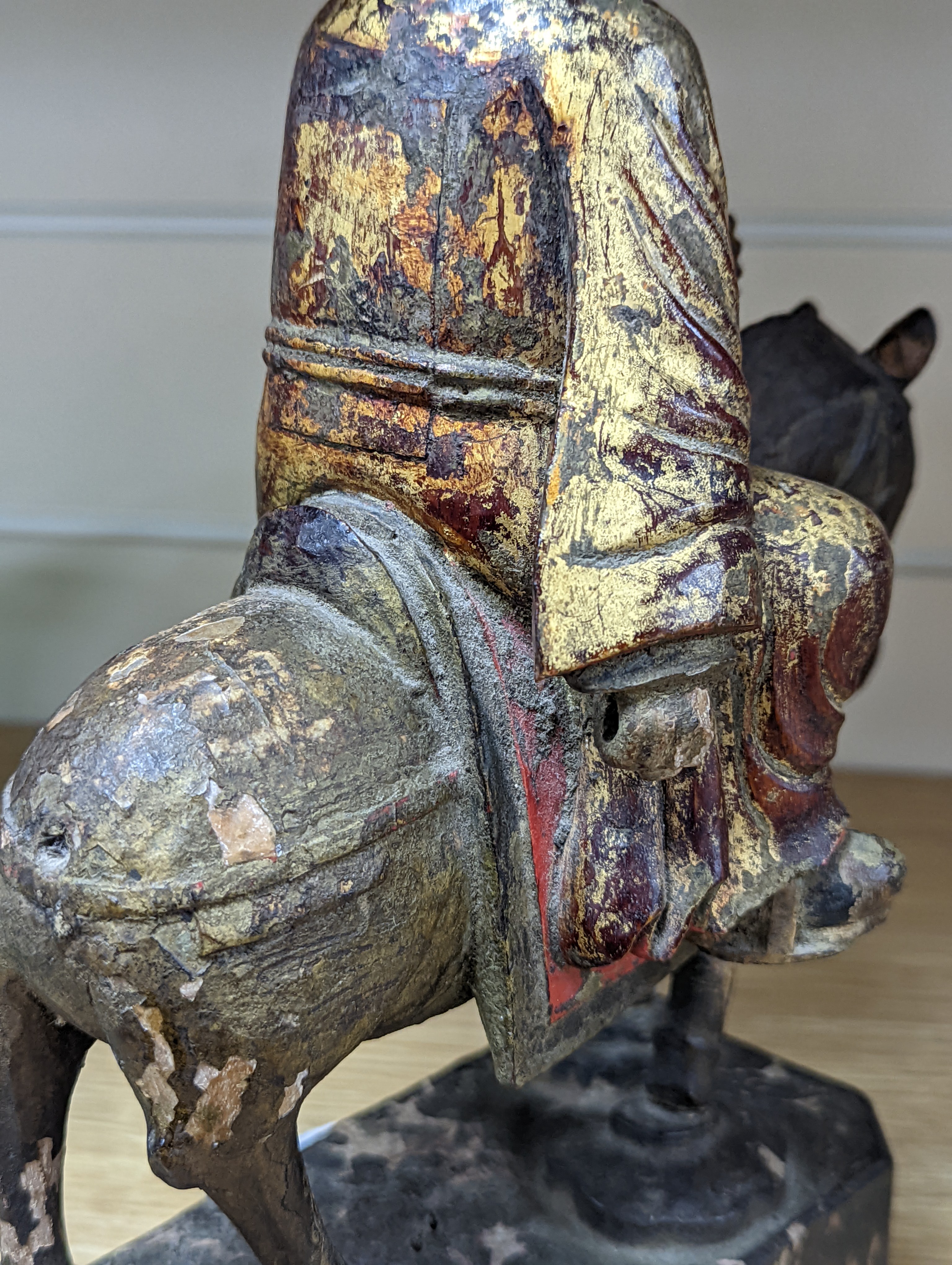 An 18th/19th century Chinese lacquered wood group of an official riding a horse, 30cm
